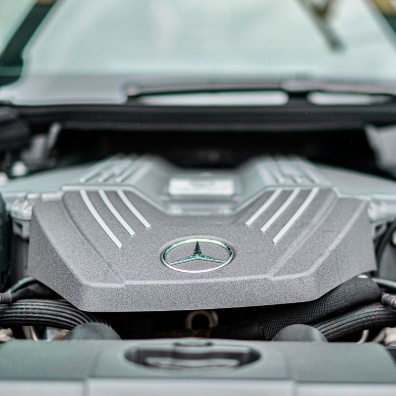 A detailed close-up shows the clean and complex engine bay of a high-performance foreign vehicle. A detailed close-up shows the clean and complex engine bay of a high-performance foreign vehicle.